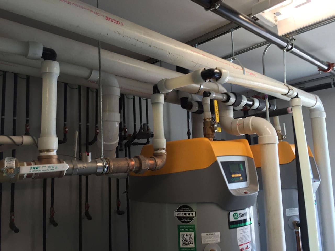 Master Plumbing technician servicing a water heater